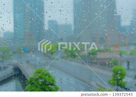 Rainy cityscape visible from the window Rainy cityscape visible from the window 139372543
