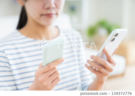 A young woman with a portable battery A young woman with a portable battery 139372776