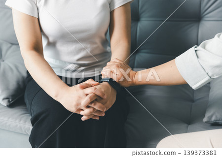 Mental health support concept with therapist comforting anxious person during counseling session at home, showing empathy, care, trust, emotional healing, reassurance and psychological support. Mental health support concept with therapist comforting anxious person during counseling session at home, showing empathy, care, trust, emotional healing, reassurance and psychological support. 139373381