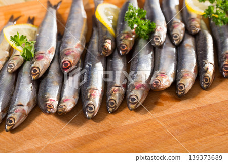 Marinated European anchovies with greens and lemon Marinated European anchovies with greens and lemon 139373689