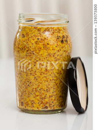 Grainy mustard in open glass jar 139373800