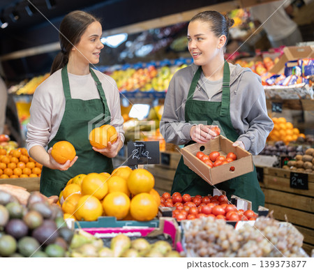 Owners of the grocery store hold ripe fruit in their hands Owners of the grocery store hold ripe fruit in their hands 139373877