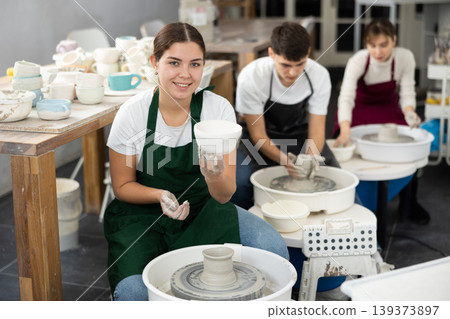 Young woman holding crafted clay cup Young woman holding crafted clay cup 139373897