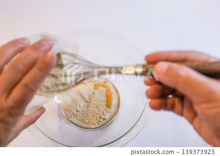 Preparing the choux pastry dough by mixing eggs and flour, and the steps involved in making the pastry. Preparing the choux pastry dough by mixing eggs and flour, and the steps involved in making the pastry. 139373923
