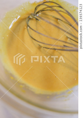 The process of mixing choux pastry dough with a whisk - the steps involved in making sweets. The process of mixing choux pastry dough with a whisk - the steps involved in making sweets. 139374123
