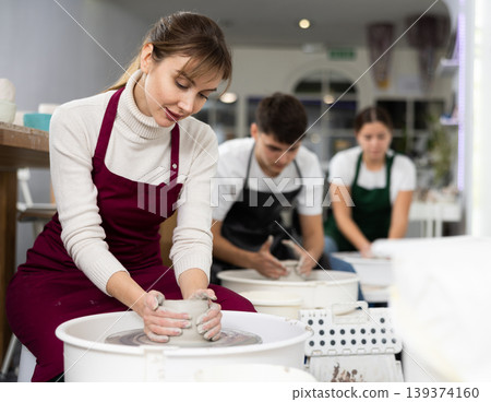 Woman working with pottery wheel 139374160