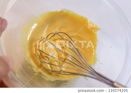 The process of mixing choux pastry dough with a whisk - the steps involved in making sweets. The process of mixing choux pastry dough with a whisk - the steps involved in making sweets. 139374205