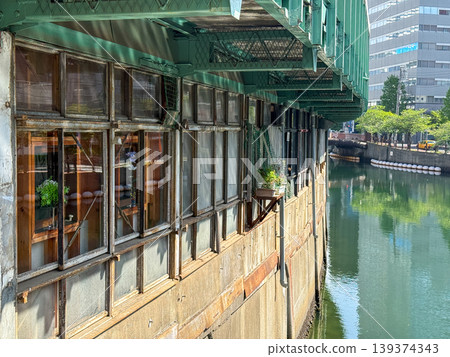 The soft spring light filtering through Yokohama's canals and the historical scenery beneath the elevated railway tracks. April 20, 2026, Yokohama City, Sunday 139374343
