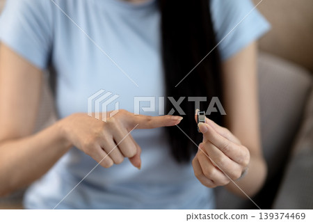 Asian adult woman hand holds modern smart ring device pointing at innovative wearable technology promoting health wellbeing digital lifestyle Asian adult woman hand holds modern smart ring device pointing at innovative wearable technology promoting health wellbeing digital lifestyle 139374469