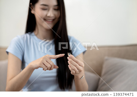 Asian young adult woman holding microchip explaining advanced technology presenting innovation smart device home setting demonstrating future discovery Asian young adult woman holding microchip explaining advanced technology presenting innovation smart device home setting demonstrating future discovery 139374471