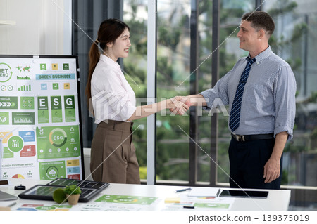 Business Professionals Shaking Hands Green Business ESG Sustainability Strategy Office Meeting Collaboration Business Professionals Shaking Hands Green Business ESG Sustainability Strategy Office Meeting Collaboration 139375019