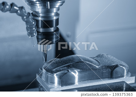 High-precision CNC milling machine performing a finish cut on mold parts using a ball nose end mill. 139375363