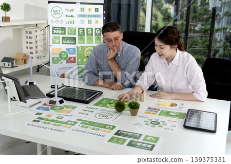 caucasian businessman and asian businesswoman discussing ESG strategy caucasian businessman and asian businesswoman discussing ESG strategy 139375381