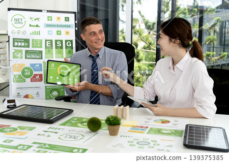 caucasian businessman and asian businesswoman discussing ESG strategy caucasian businessman and asian businesswoman discussing ESG strategy 139375385