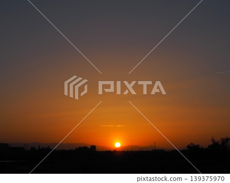 The sunset sky is painted orange, and the sun sinks over the Kanto Mountains. The sunset sky is painted orange, and the sun sinks over the Kanto Mountains. 139375970
