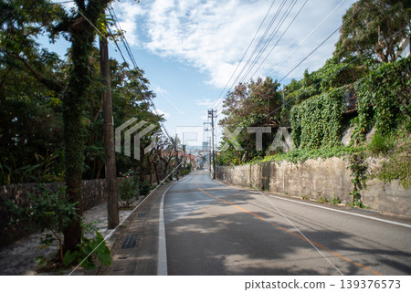 A straight, gently sloping road with a view of the town in the distance. A straight, gently sloping road with a view of the town in the distance. 139376573