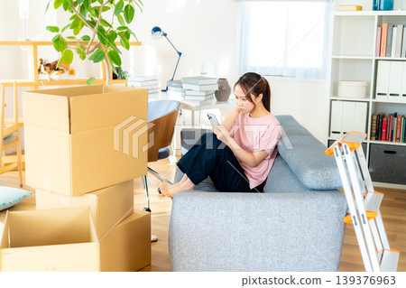 Young woman packing Young woman packing 139376963
