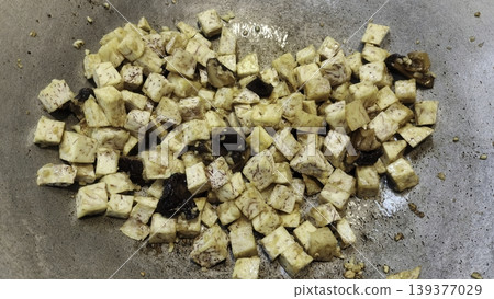 Diced Taro Root and Shiitake Mushrooms Stir-Frying in a Metal Wok for Asian Cuisine 139377029
