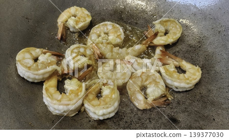 Fresh Shrimps Sauteing with Garlic in a Hot Wok - Stir Fry Cooking Concept Fresh Shrimps Sauteing with Garlic in a Hot Wok - Stir Fry Cooking Concept 139377030