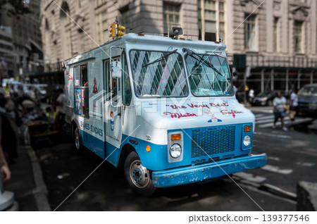 New york, usa august 16,2024. Mister softee ice cream truck parked on a sunny manhattan street curb, classic blue white soft serve vendor amid urban summer life New york, usa august 16,2024. Mister softee ice cream truck parked on a sunny manhattan street curb, classic blue white soft serve vendor amid urban summer life 139377546