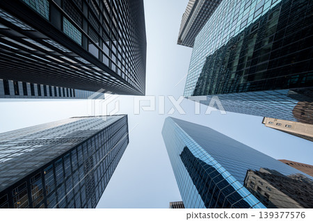 New york, usa august 16,2024. Towering glass and steel skyscrapers reflect a clear blue sky, conveying modern urban growth, ambition and corporate power New york, usa august 16,2024. Towering glass and steel skyscrapers reflect a clear blue sky, conveying modern urban growth, ambition and corporate power 139377576