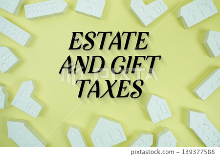 Estate and Gift Taxes! text with house models on yellow background Estate and Gift Taxes! text with house models on yellow background 139377588