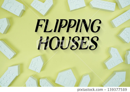 Flipping Houses text with house models on yellow background Flipping Houses text with house models on yellow background 139377589