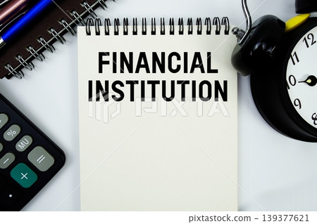 Financial Institution text written on notepad with calculator and alarm clock Financial Institution text written on notepad with calculator and alarm clock 139377621