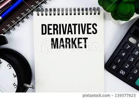 Derivatives Market text written on notepad with calculator and alarm clock 139377623