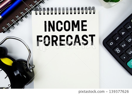 Income Forecast text written on notepad with calculator and alarm clock 139377626