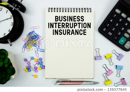 Business Interruption Insurance text written on notepad with calculator and alarm clock Business Interruption Insurance text written on notepad with calculator and alarm clock 139377645