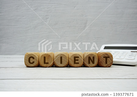 CLIENT alphabet letters with calculator on wooden background 139377671