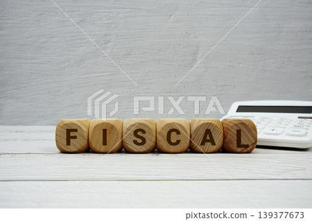 FISCAL alphabet letters with calculator on wooden background 139377673