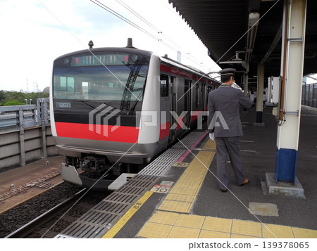A train conductor checks the time on the platform at Shin-Kiba Station on the Keiyo Line. A train conductor checks the time on the platform at Shin-Kiba Station on the Keiyo Line. 139378065