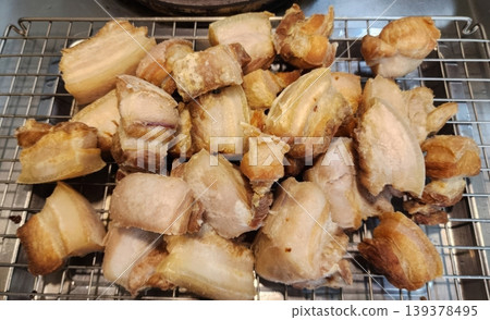Crispy Deep Fried Pork Belly Chunks Resting on a Metal Cooling Rack Crispy Deep Fried Pork Belly Chunks Resting on a Metal Cooling Rack 139378495