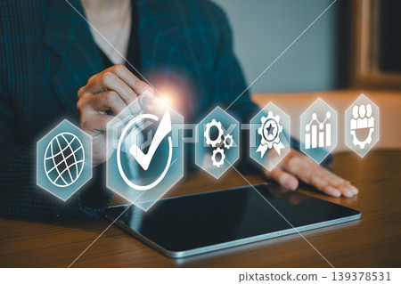 Professional using digital interface with icons representing global network, quality check, settings, and analytics. Professional using digital interface with icons representing global network, quality check, settings, and analytics. 139378531
