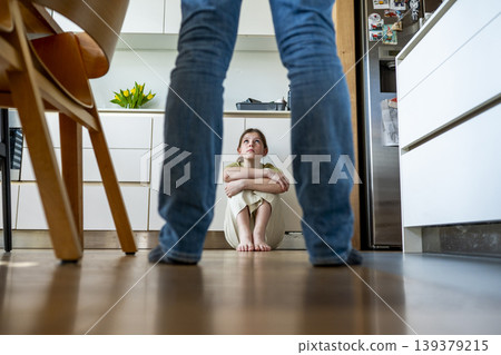 Distressed child facing aggressive parenting and emotional fear at home. 139379215