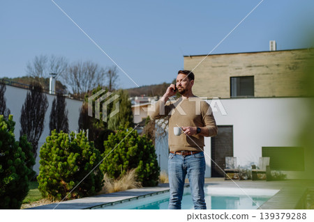Relaxed man drinking coffee on terrace at home on sunny day. Relaxed man drinking coffee on terrace at home on sunny day. 139379288