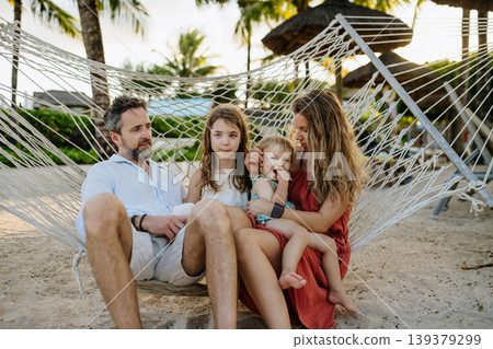 Family enjoying tropical beach vacation at luxury resort. Family enjoying tropical beach vacation at luxury resort. 139379299