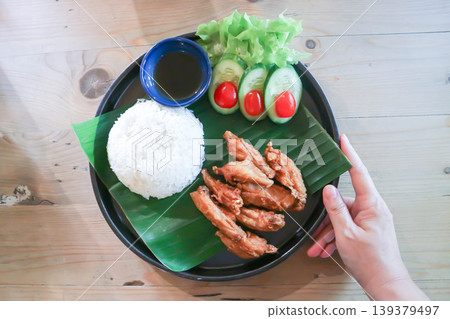 chicken wings or deep fried chicken , fried chicken with rice and sauce or chicken and rice 139379497