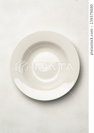 Empty white plate on light background Empty white plate on light background 139379880