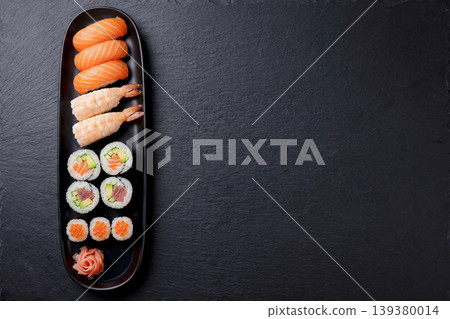 Sushi platter arranged against a black background Sushi platter arranged against a black background 139380014