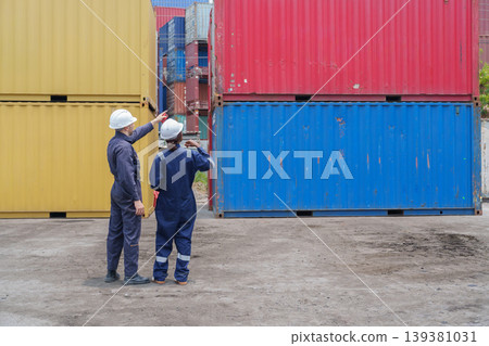 Mid-adult Caucasian Male and Black Female Logistics Workers Coordinating Cargo at Terminal 139381031