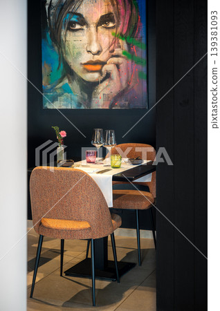 Romantic table with soft ambiance. Elegant dinner scene featuring artwork and dim lighting ambiance 139381093