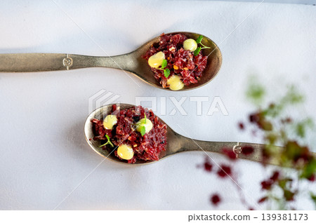 Elegant table setting. Lavish dining space illuminated softly with meticulously organized silverware Elegant table setting. Lavish dining space illuminated softly with meticulously organized silverware 139381173