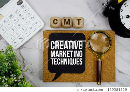 CMT Creative Marketing Techniques text with calculator, magnifying glass and alarm clock on marble background 139381219
