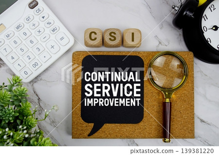 CSI Continual Service Improvement text with calculator, magnifying glass and alarm clock on marble background 139381220