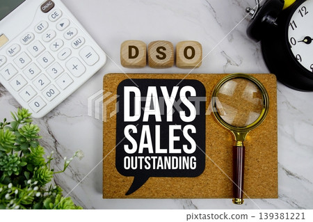 DSO Days Sales Outstanding text with calculator, magnifying glass and alarm clock on marble background DSO Days Sales Outstanding text with calculator, magnifying glass and alarm clock on marble background 139381221