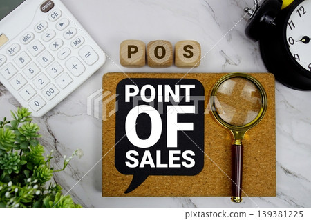 POS Point Of Sales text with calculator, magnifying glass and alarm clock on marble background POS Point Of Sales text with calculator, magnifying glass and alarm clock on marble background 139381225