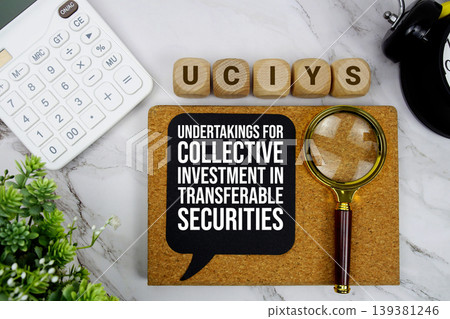 UCITS Undertakings for Collective Investment in Transferable Securities text with calculator, magnifying glass and alarm clock on marble background UCITS Undertakings for Collective Investment in Transferable Securities text with calculator, magnifying glass and alarm clock on marble background 139381246